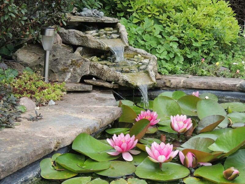 Decorative fountain in landscaped patio setting