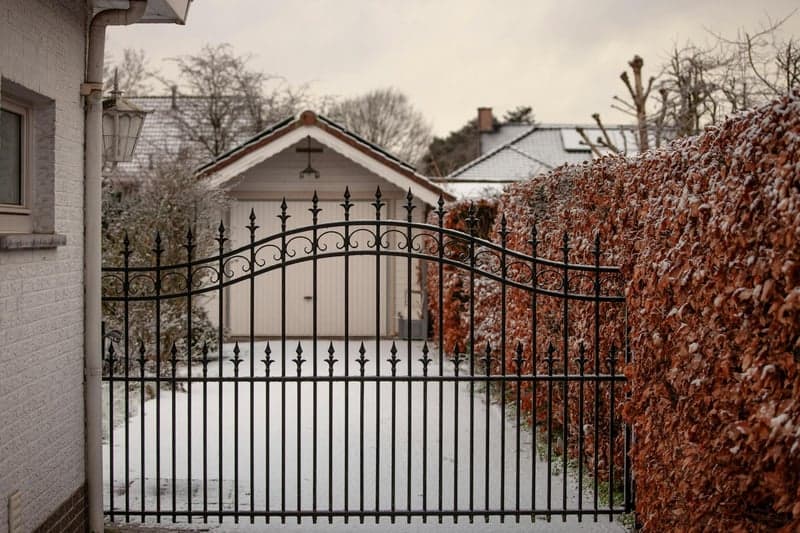 Clean white vinyl fence installed on a residential property